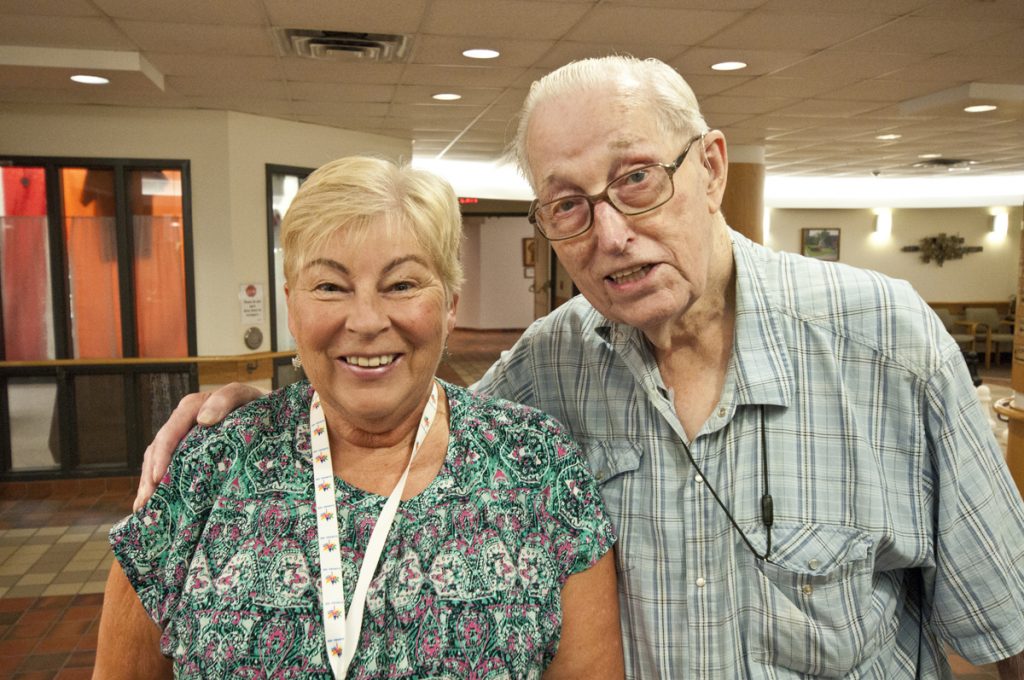 A photo of a elderly couple inside the Trinity Tower Lounge area.