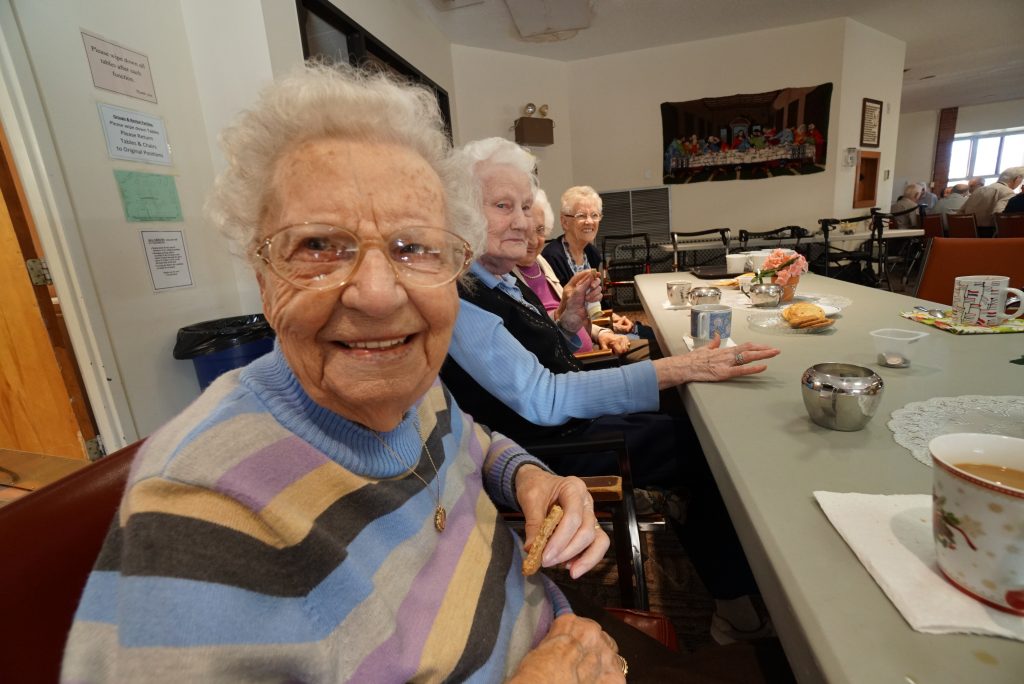 A photo of elderly women enjoying a meal inside Horizon Hall.