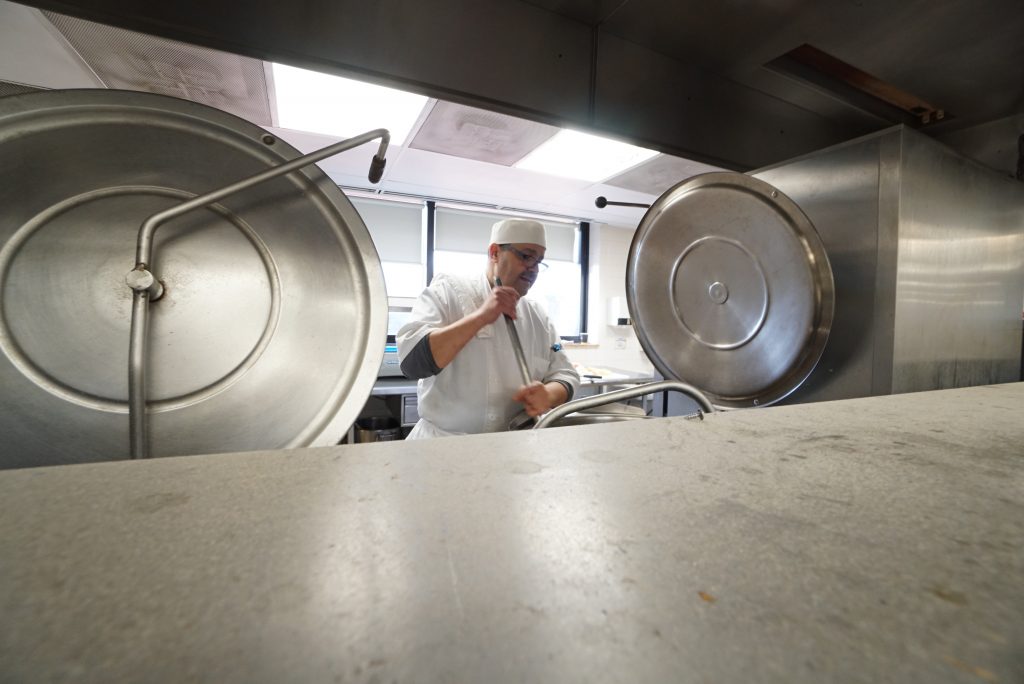 A photo of a dietary chef cleaning the dietary kitchen.