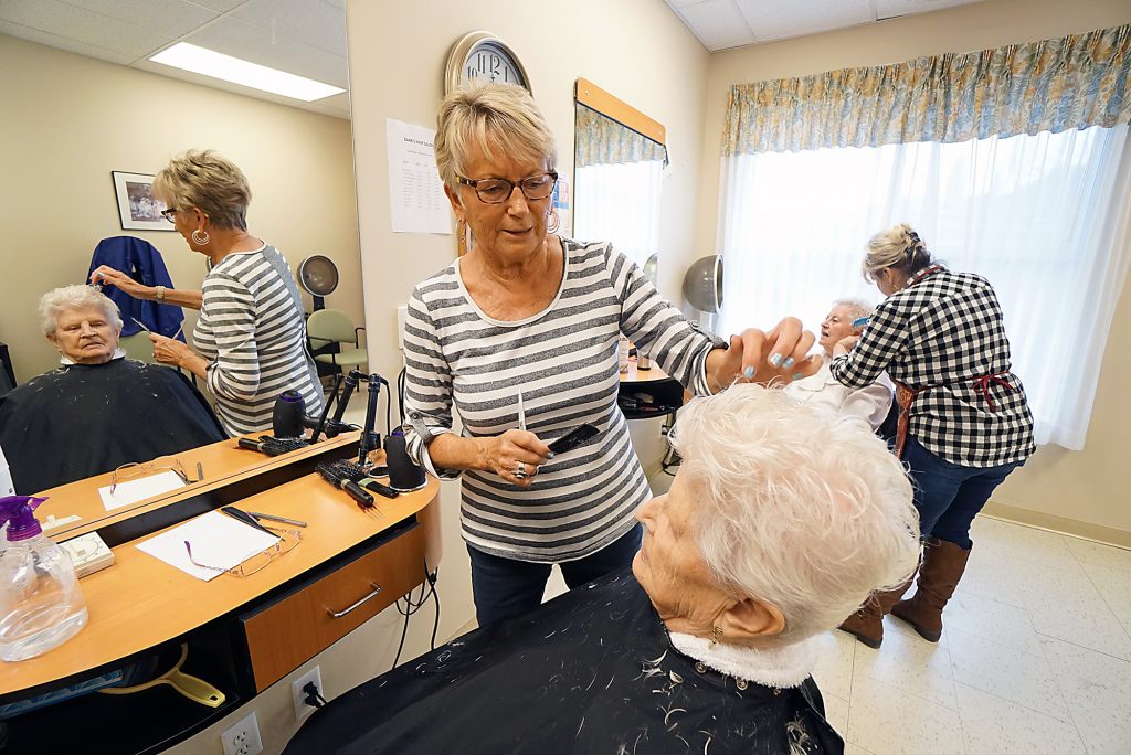 A photo of Hairdressers servicing residents and tenants in the Hair Salon.