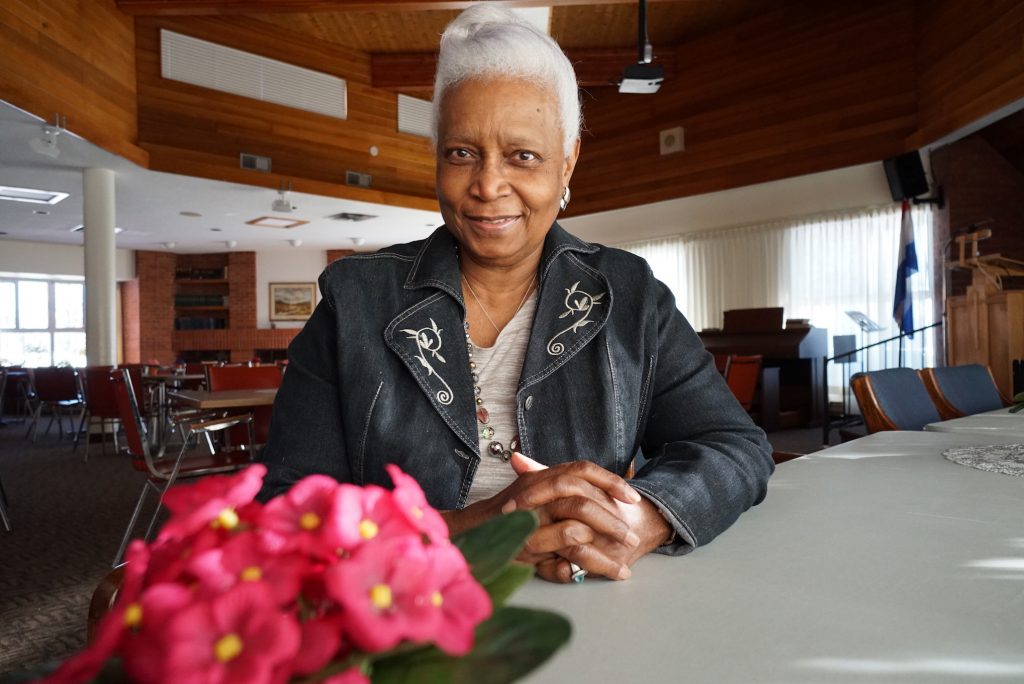 A photo of a smiling elderly woman in Horizon Hall.