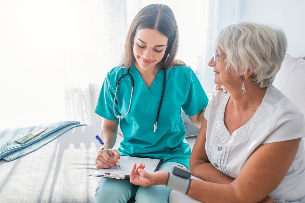 A photo of a nurse performing a routine checkup on a tenant living in one of the towers. This is part of the Assisted Living Services to High Risk Seniors Program.