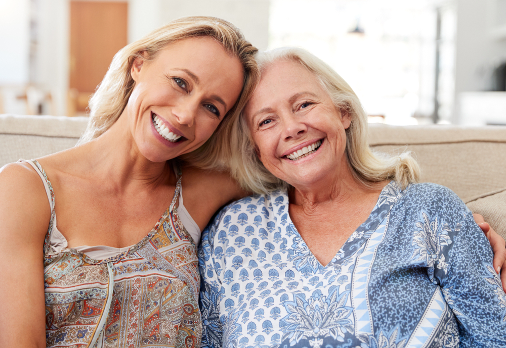 A photo of a lady hugging their elder relative.