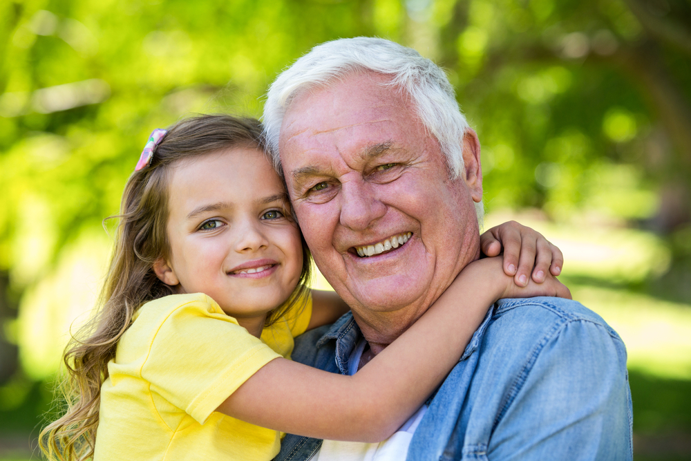 A photo of a elderly man hugging a relative.
