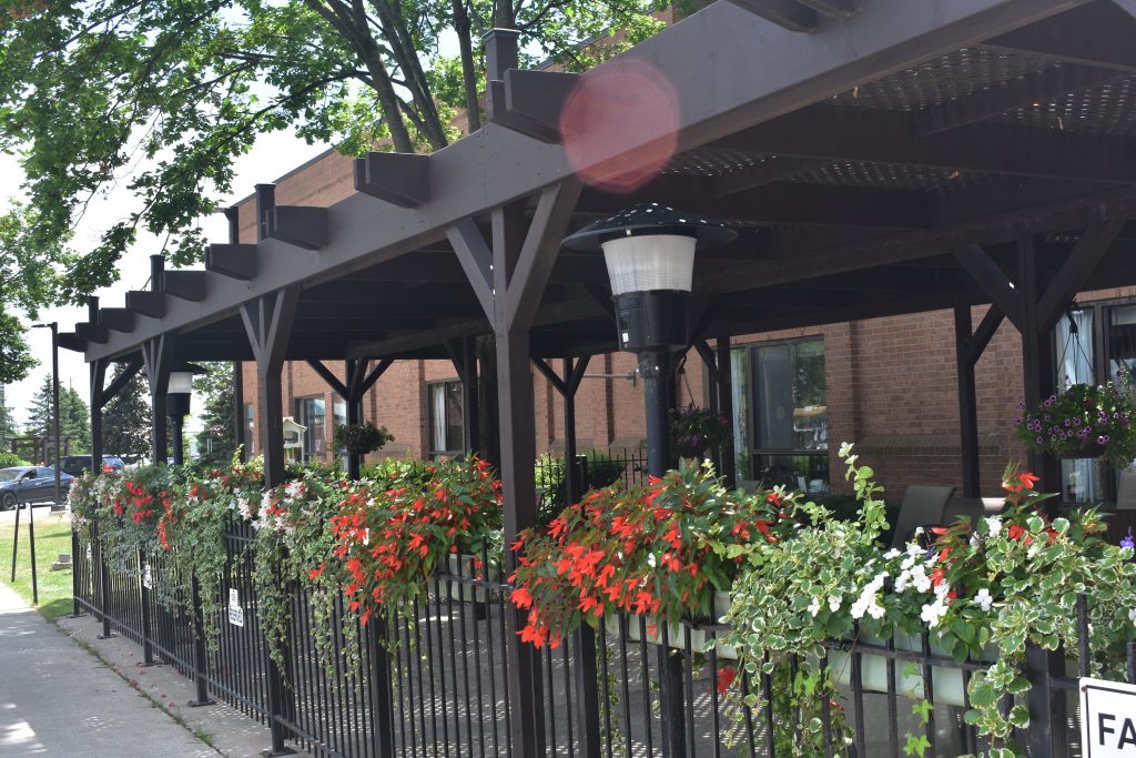 A photo of a outdoor gated sitting area at the front of Old Faith Manor.